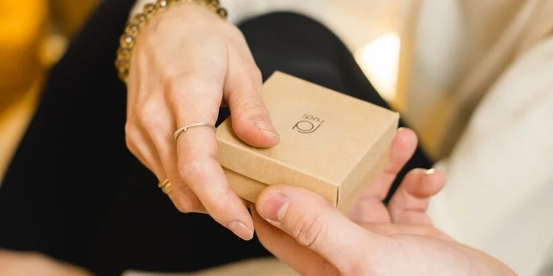 woman in white dress holding gold iphone 6